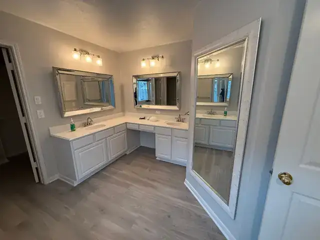 Finished primary bathroom with double vanity and new flooring