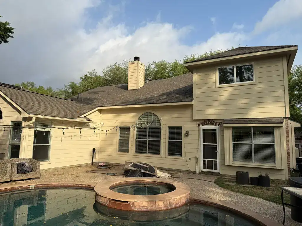 Finished home exterior with pool, new siding and roof