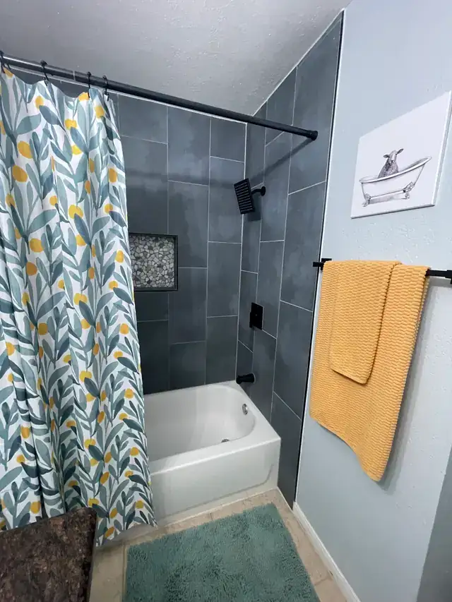 Completed bathroom shower and tub remodel in grey tile