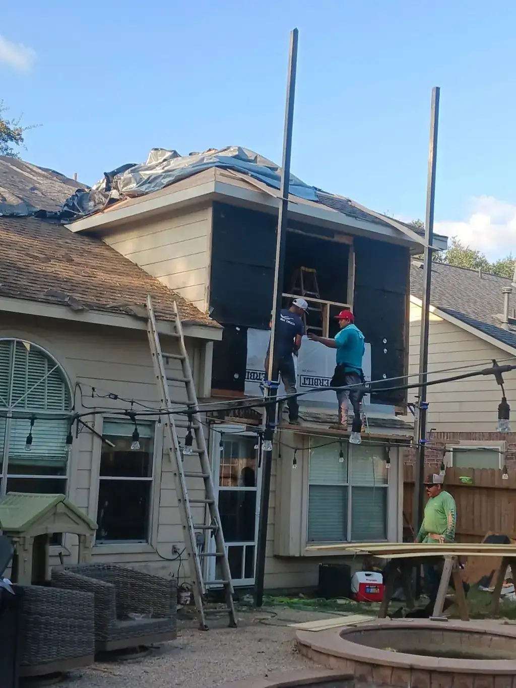 ProRoofs and Restoration crew repairing a storm damaged roof section